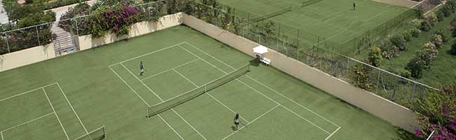 guests playing tennis in Kalimera Kriti Hotel's courts